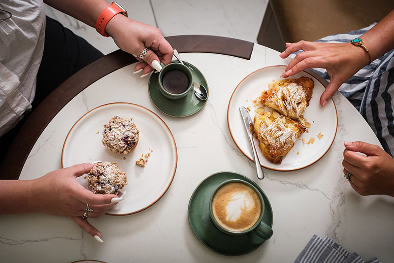 two friends enjoying a breakfast spread